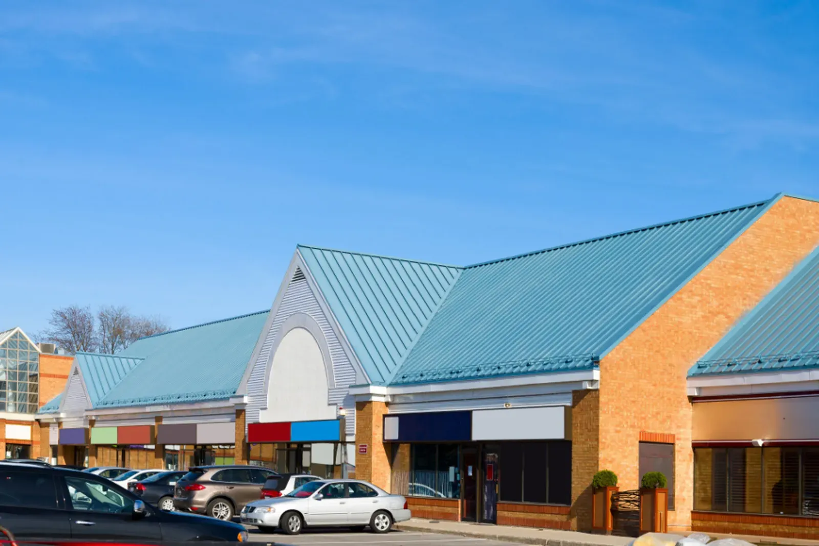 A new metal roof being installed on a commercial building. | New Jersey Gutter