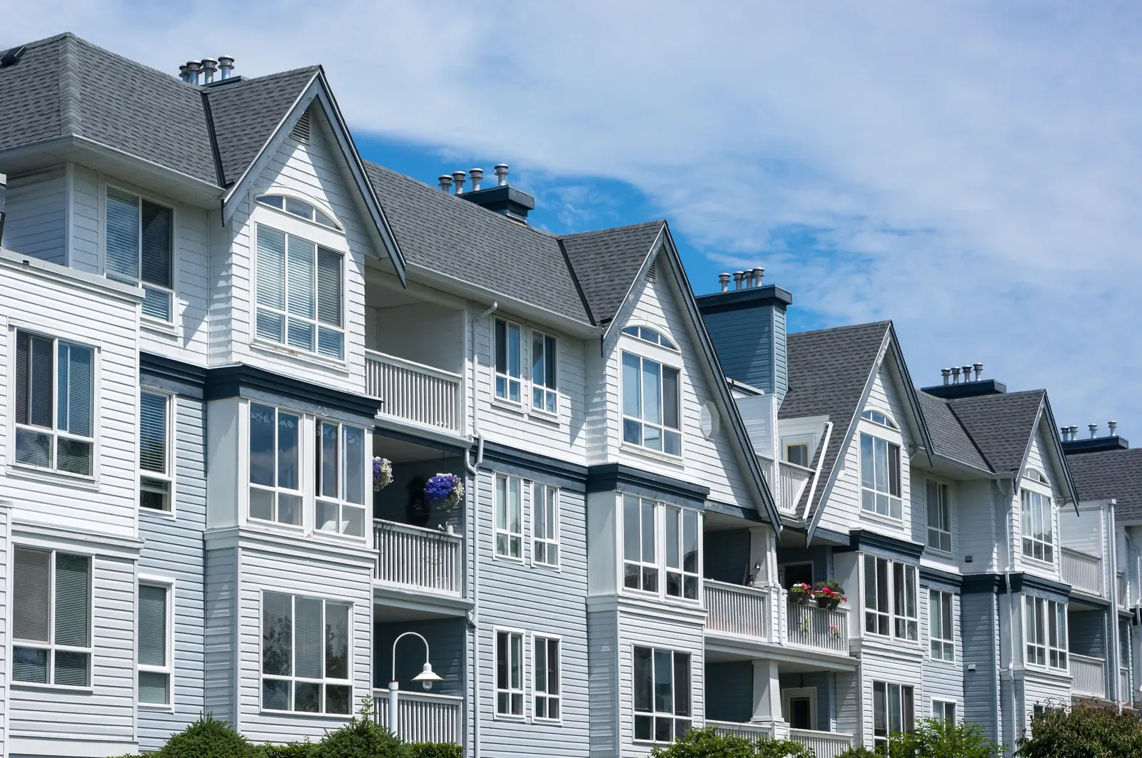 A newly installed asphalt roof and vinyl siding on a multi-family property. | New Jersey Gutter