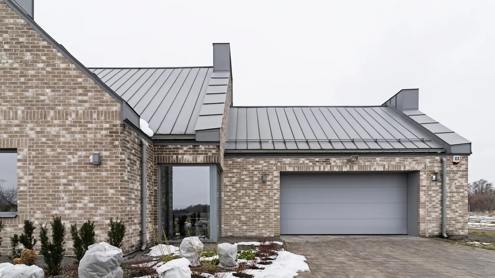 A metal roof being installed on a residential building. | New Jersey Gutter