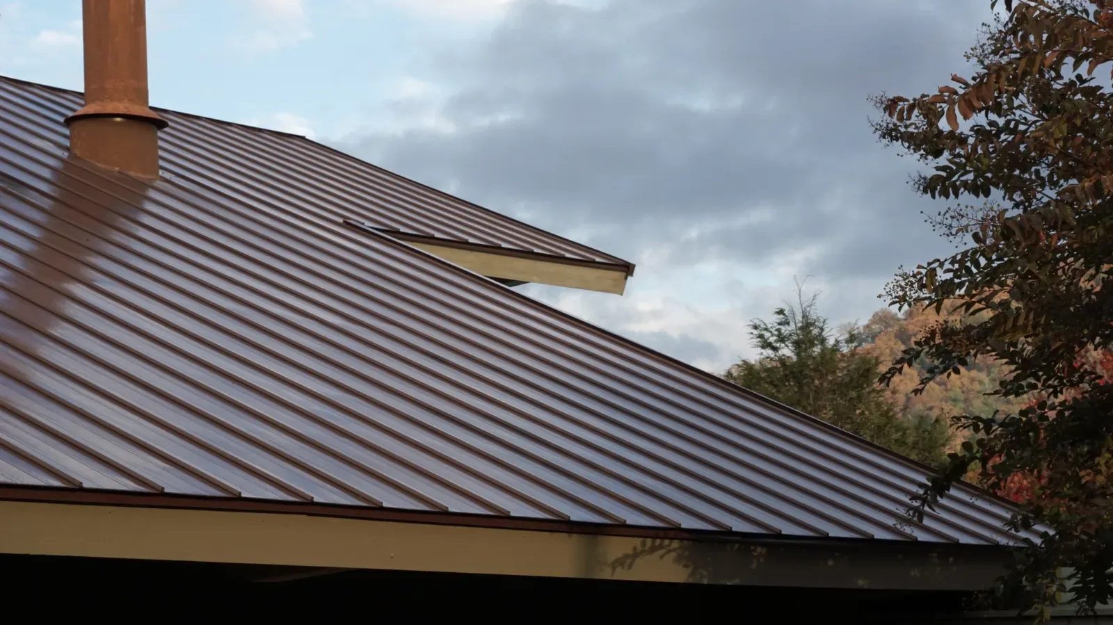 A professional roofer installing a metal roof on a residential building. | New Jersey Gutter